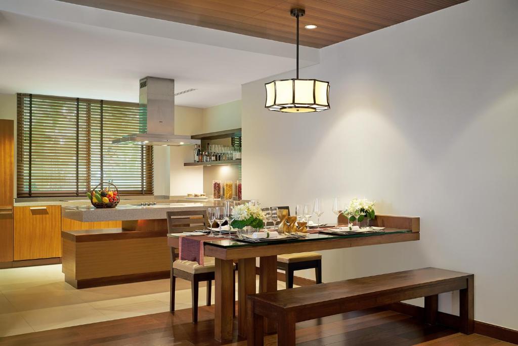 a kitchen and dining room with a table and chairs at Mövenpick Resort Bangtao Beach Phuket in Bang Tao Beach