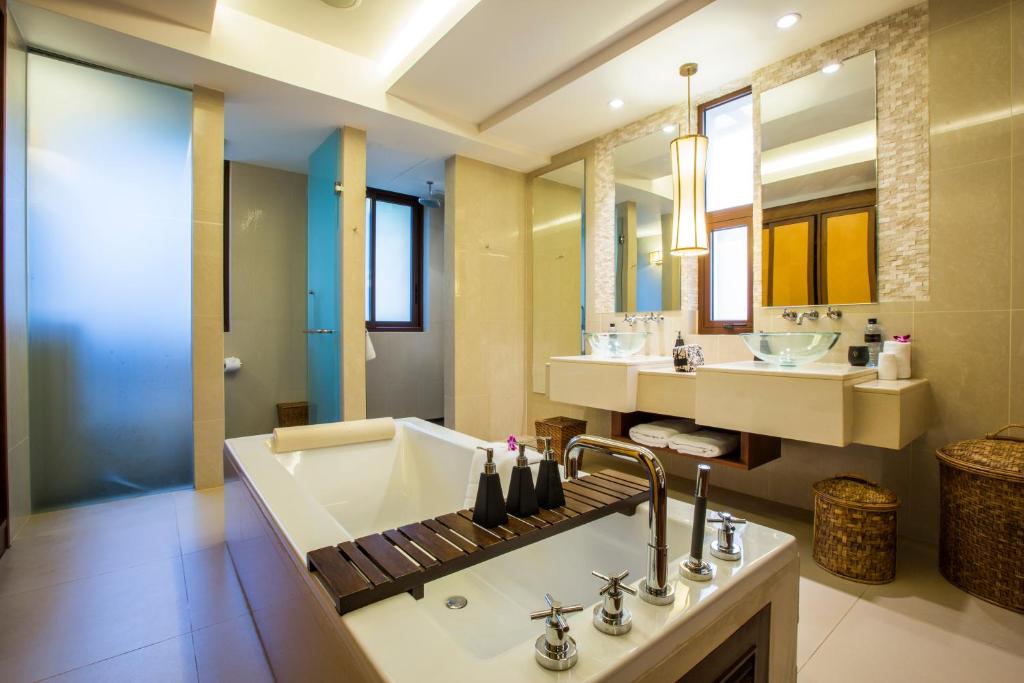 a bathroom with a sink and a large mirror at Mövenpick Resort Bangtao Beach Phuket in Bang Tao Beach
