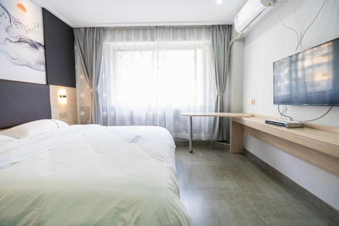 Postel nebo postele na pokoji v ubytování  Shenzhen Hualian Boutique Hotel