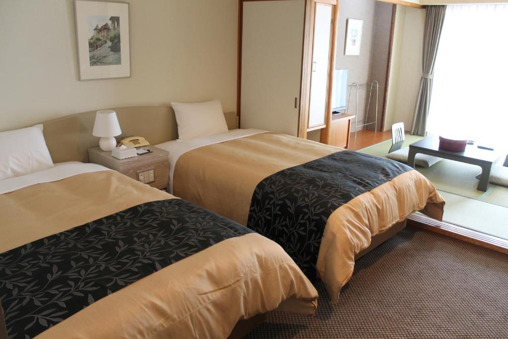 Postel nebo postele na pokoji v ubytování The Gran Resort Princess Arima