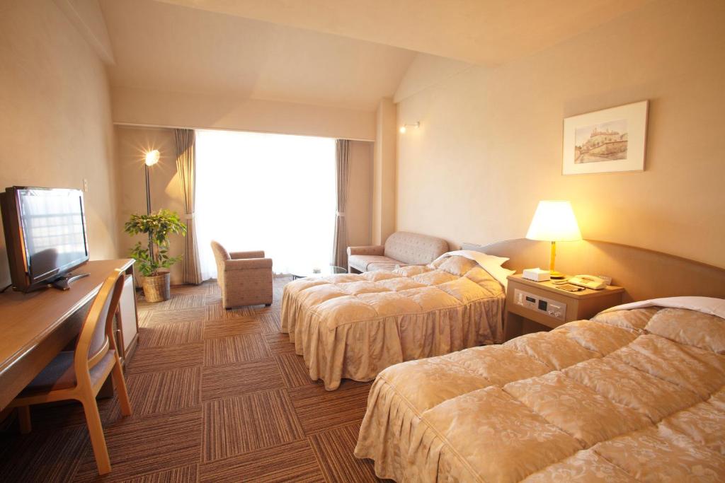 Postel nebo postele na pokoji v ubytování The Gran Resort Princess Arima