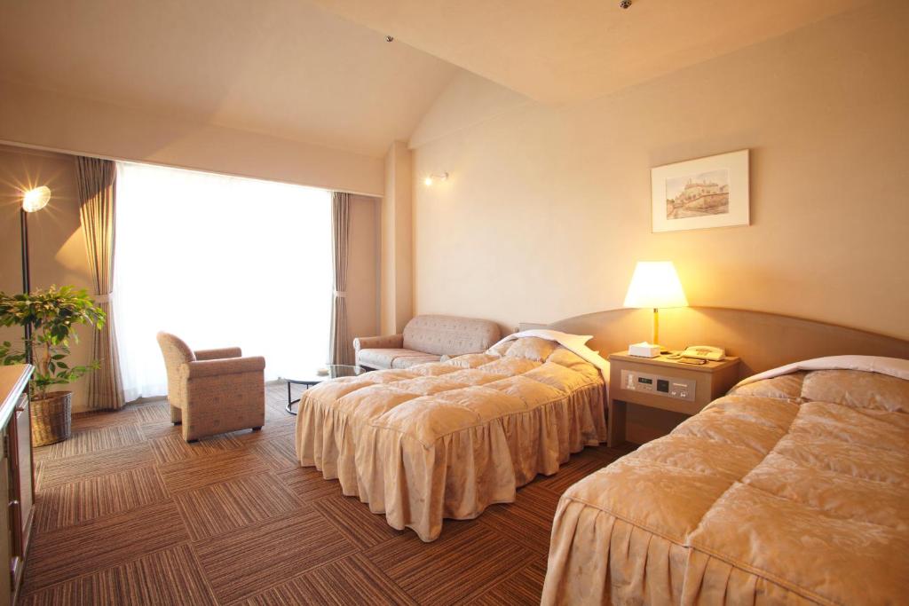 Postel nebo postele na pokoji v ubytování The Gran Resort Princess Arima