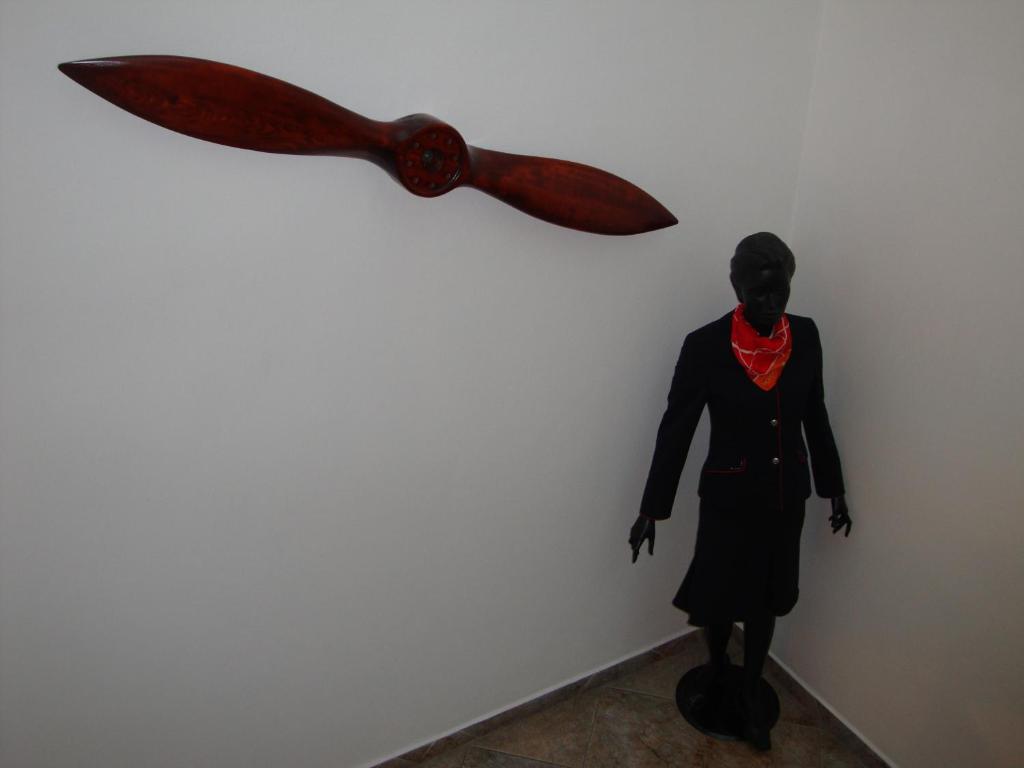 a statue of a woman with a knife on a wall at Penzion Aviatik in Čáslav