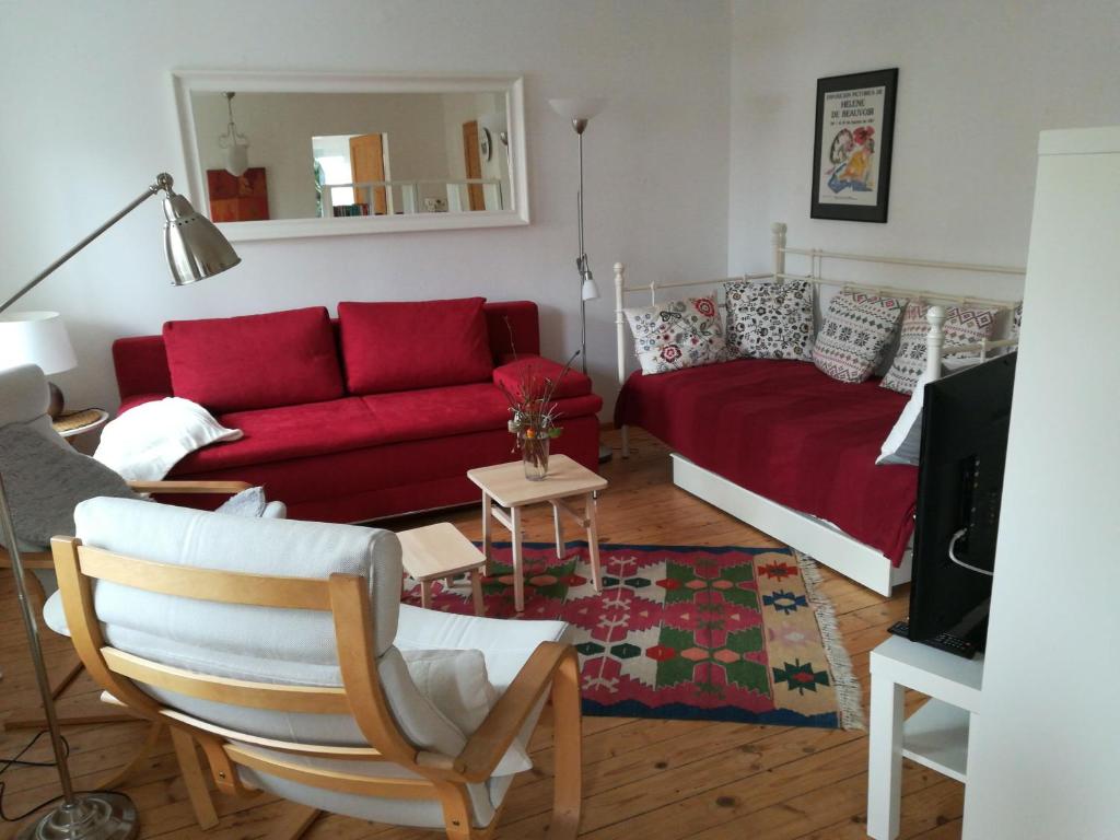 a living room with a red couch and a red couch at Haus Toni in Bad Füssing