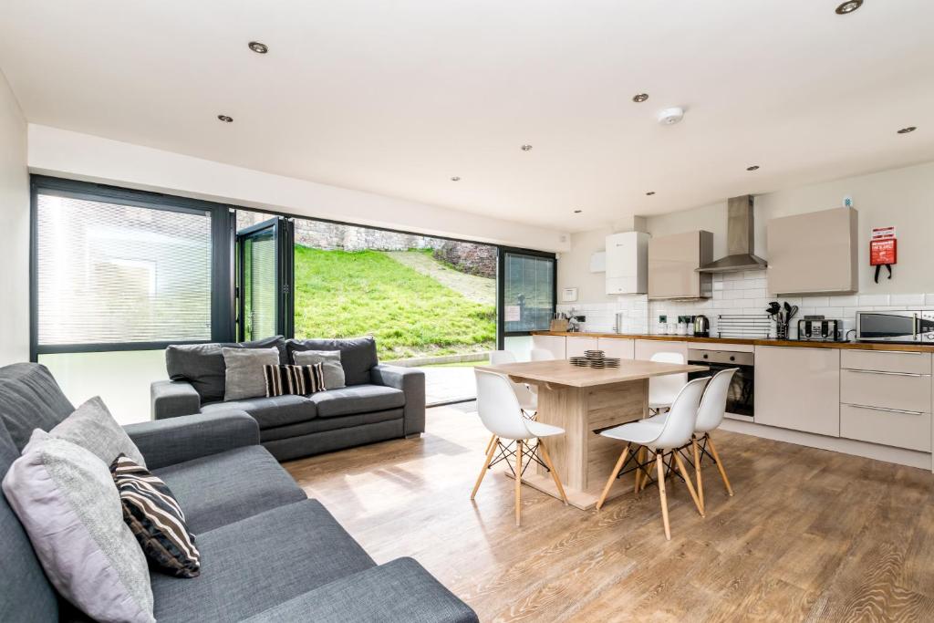 a living room with a couch and a table at City Apartments - Monkbar Mews in York