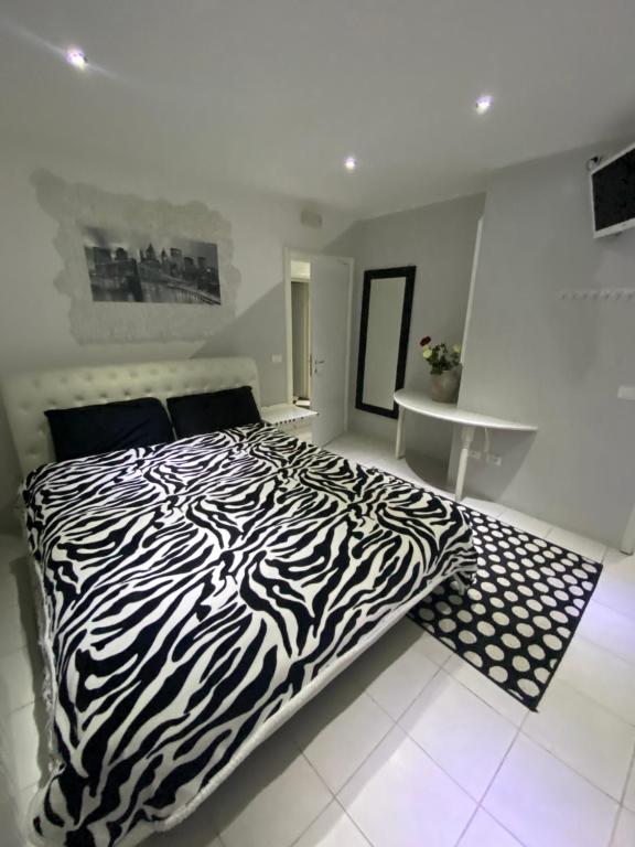 a zebra print bed in a bedroom with a table at B & Baichin in Staranzano