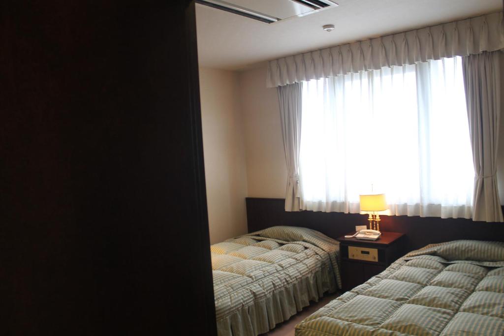Postel nebo postele na pokoji v ubytování The Gran Resort Oumi Maiko