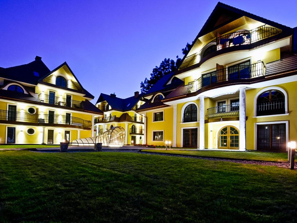 a large building with a green lawn in front of it at Apartamenty Sienkiewicza 12 in Zakopane
