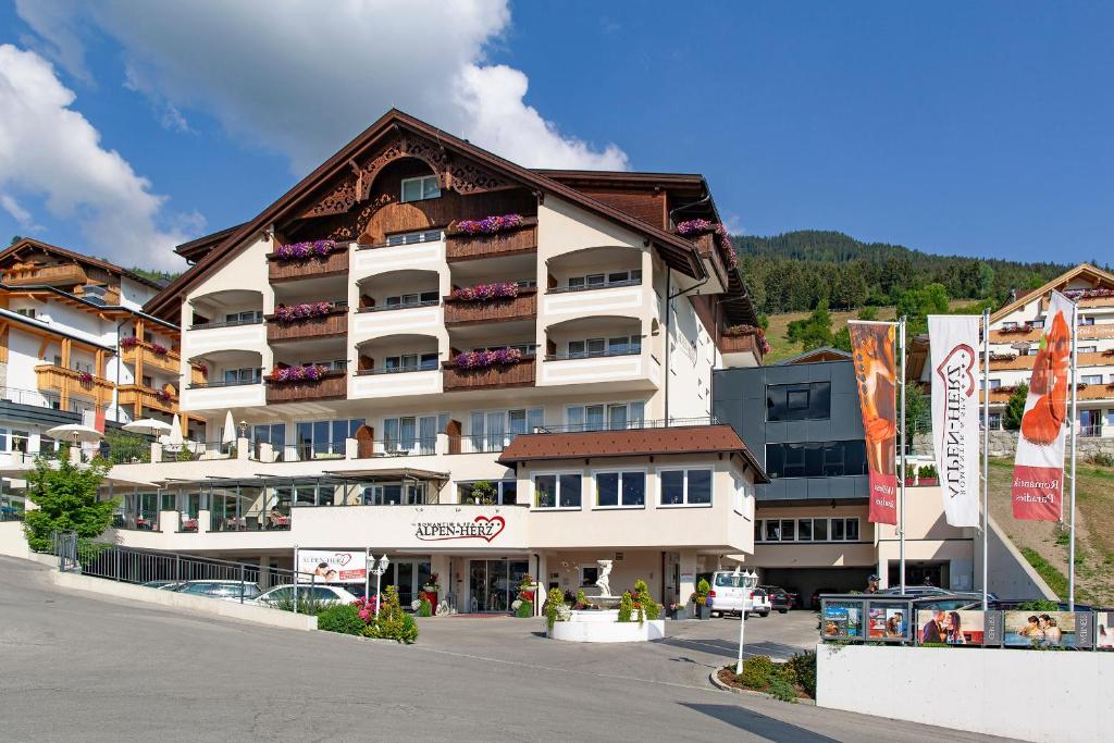 a large apartment building in the middle of a street at Alpen-Herz Romantik & Spa - Adults Only in Ladis