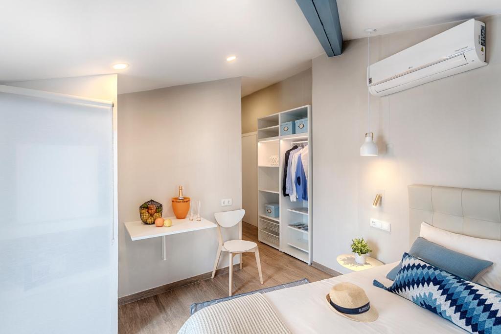 a bedroom with a bed and a desk in a room at Hostal Altea House in Altea