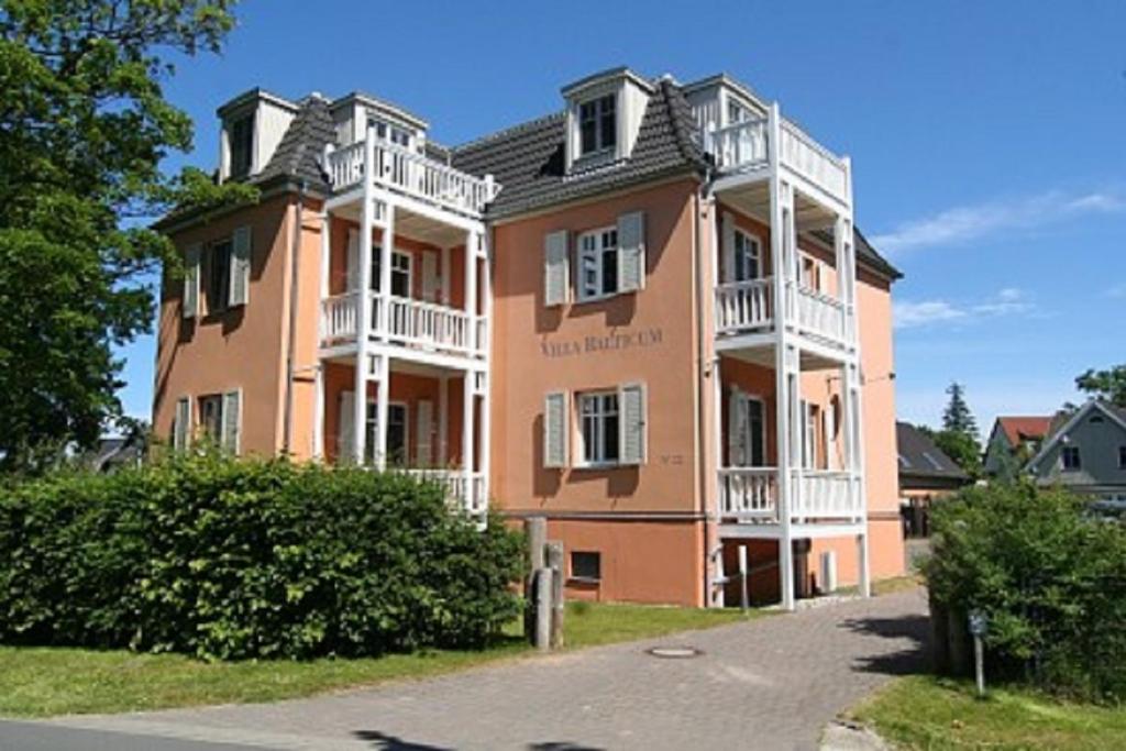 a large pink building with white balconies on it at Villa Balticum in Zingst