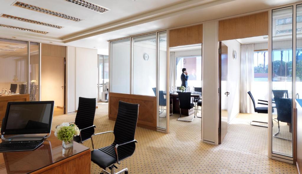 an office with a desk with a laptop and chairs at Intercontinental Cairo Citystars by IHG in Cairo
