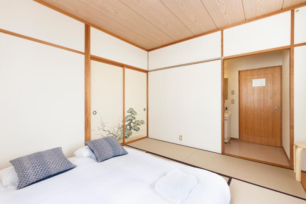 Postel nebo postele na pokoji v ubytování Nozawa Peaks