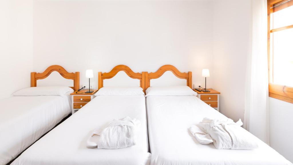 Postel nebo postele na pokoji v ubytování Hostal Trainera