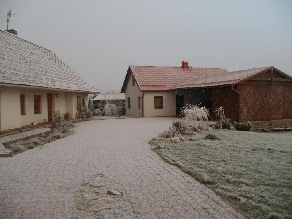 a brick driveway in front of two buildings at Talsu Pirtiņa Vijoles in Talsi