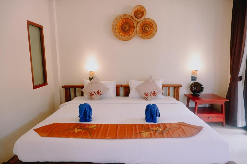 A bed or beds in a room at Wind Beach Resort