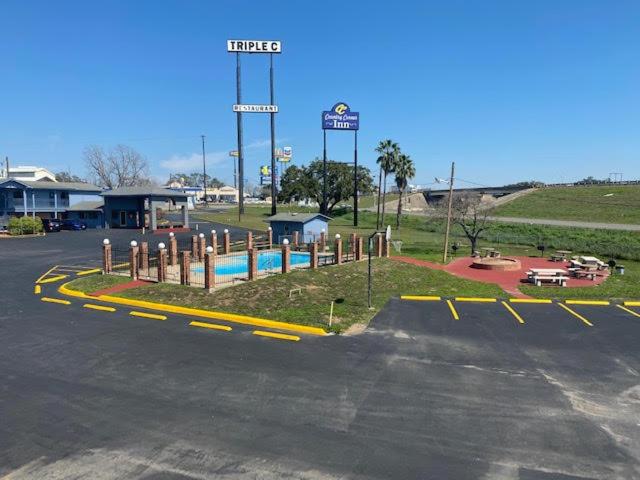 an empty parking lot with a pool in the middle at THE COUNTRY CORNER INN in Devine