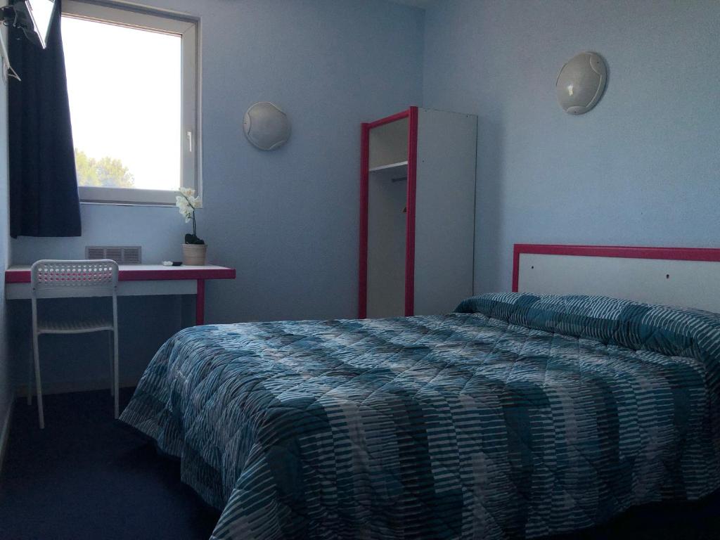 Postel nebo postele na pokoji v ubytování Hôtel Triotel