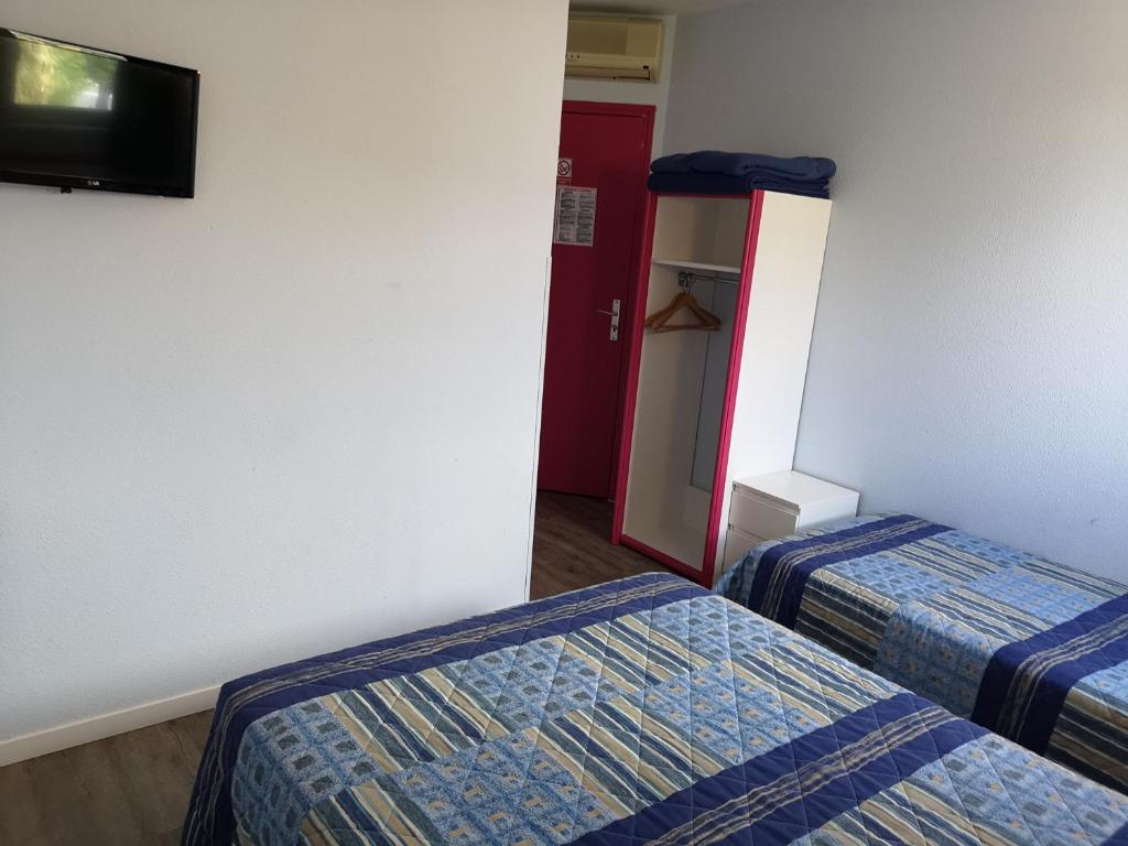 Postel nebo postele na pokoji v ubytování Hôtel Triotel