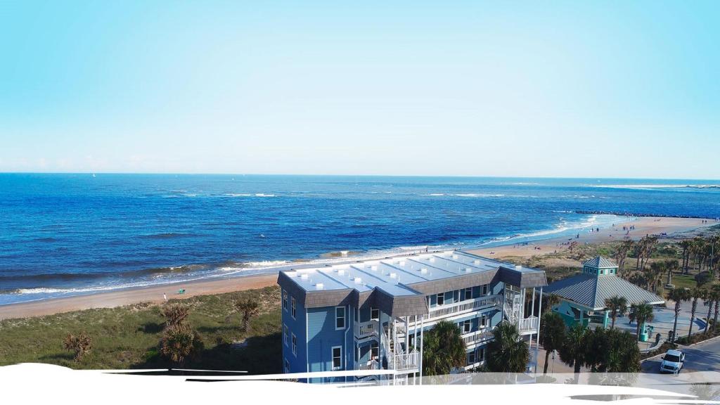 a building on a beach next to the ocean at The Saint Augustine Beach House in Saint Augustine