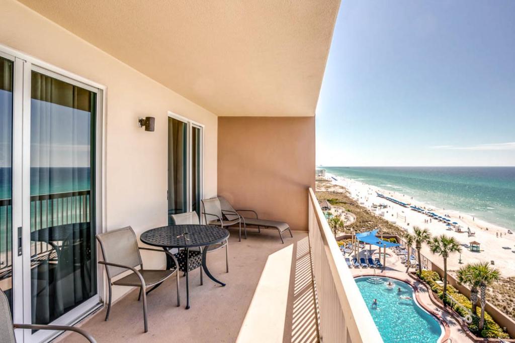 a balcony with a table and chairs and the beach at Sunrise Beach Resort IV in Panama City Beach