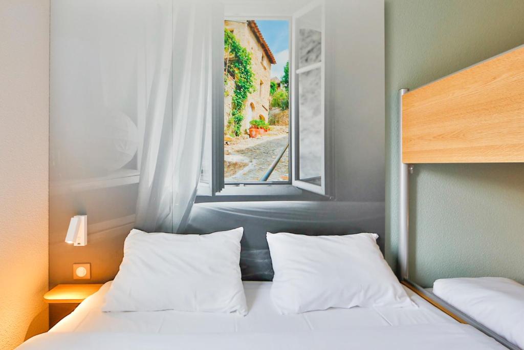 Postel nebo postele na pokoji v ubytování B&B HOTEL Valence Sud