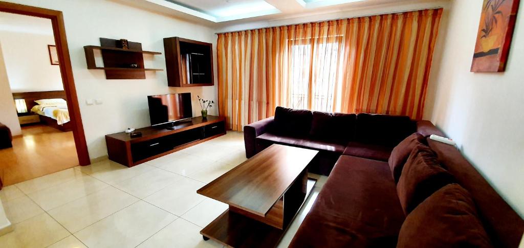 a living room with a couch and a coffee table at GrandVille Apartments in Bucharest