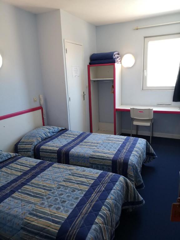 Postel nebo postele na pokoji v ubytování Hôtel Triotel