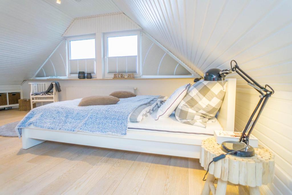 ein Schlafzimmer mit einem Bett im Dachgeschoss in der Unterkunft Perfekte Wohnung in perfekter Lage mit Balkon! in Westerland