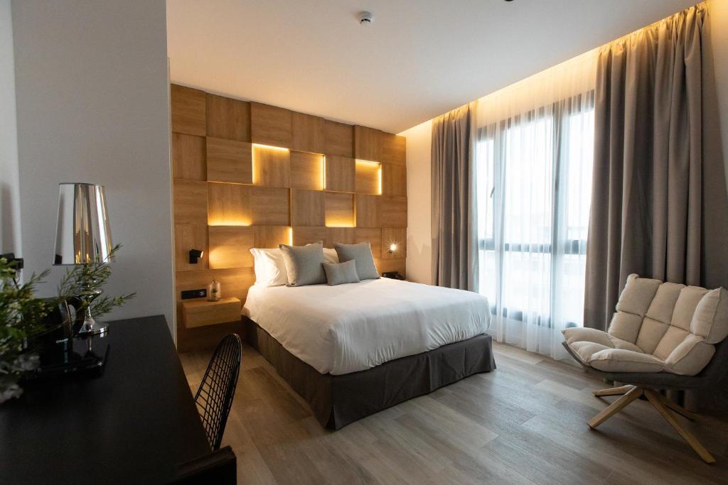 a hotel room with a bed and a desk and chair at Old Port Hotel in Limassol