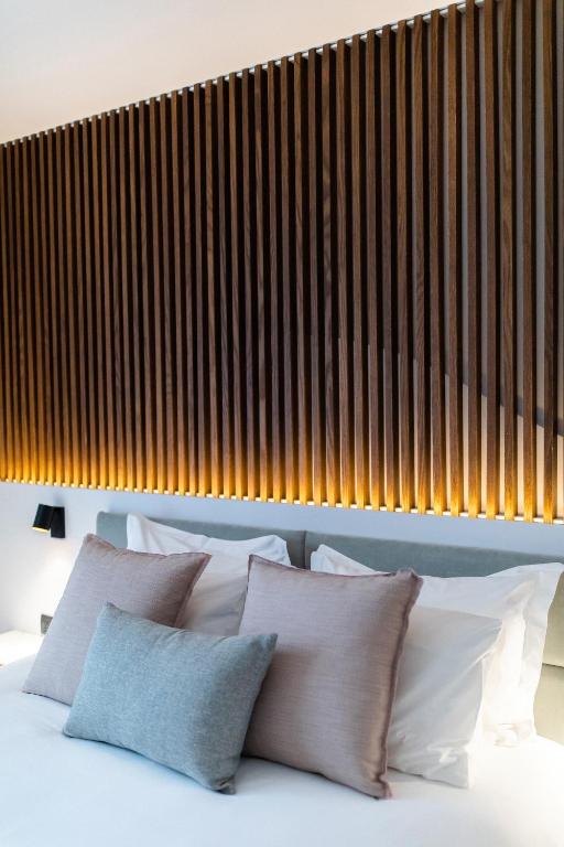 a bedroom with a bed with white pillows at Old Port Hotel in Limassol