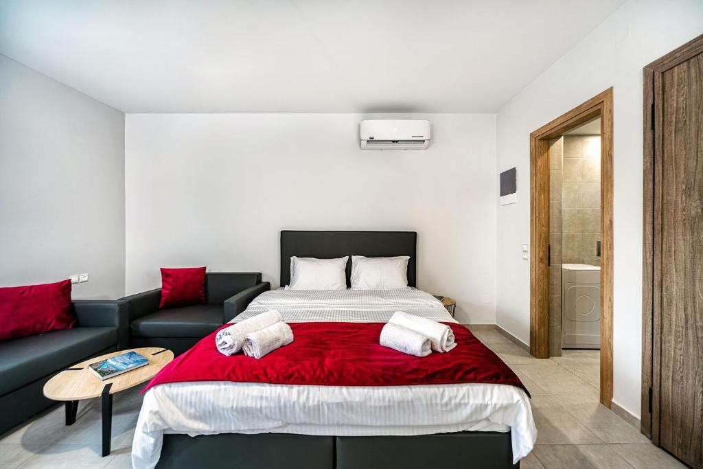 a bedroom with a bed and a couch at Elia Tree Studios in Heraklio Town