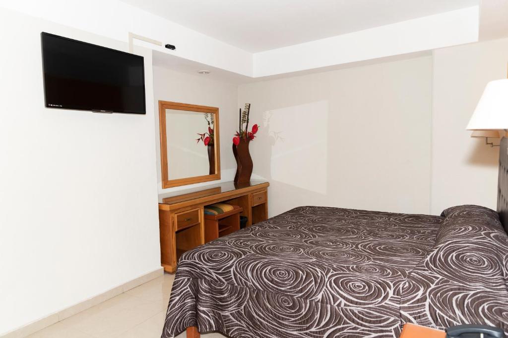 Postel nebo postele na pokoji v ubytování Hotel Gran Via - Centro