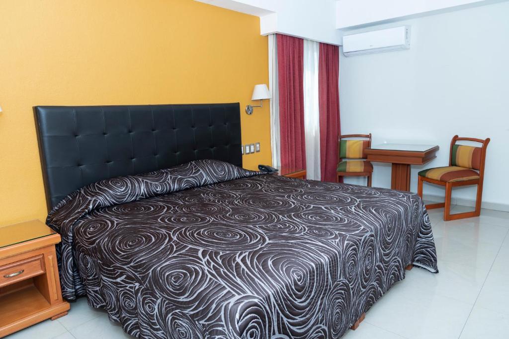 Postel nebo postele na pokoji v ubytování Hotel Gran Via - Centro
