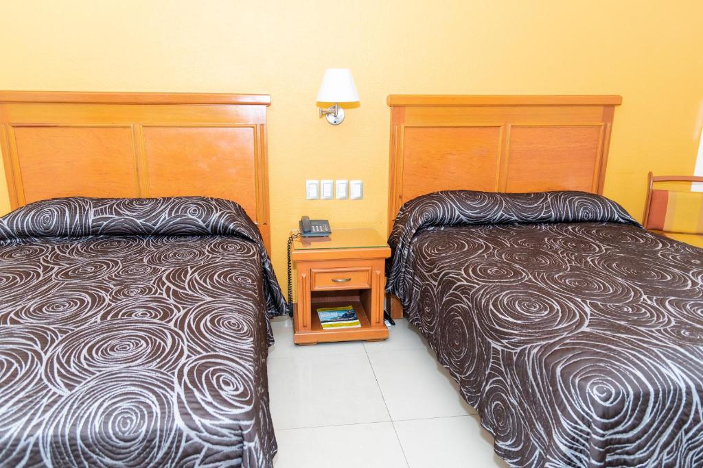 Postel nebo postele na pokoji v ubytování Hotel Gran Via - Centro