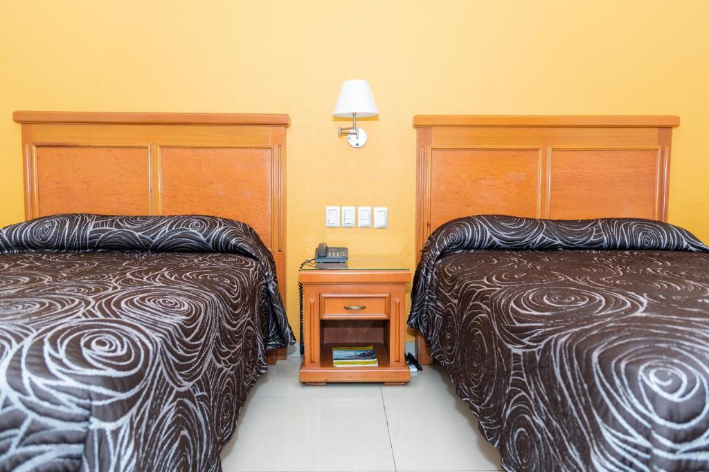 Postel nebo postele na pokoji v ubytování Hotel Gran Via - Centro