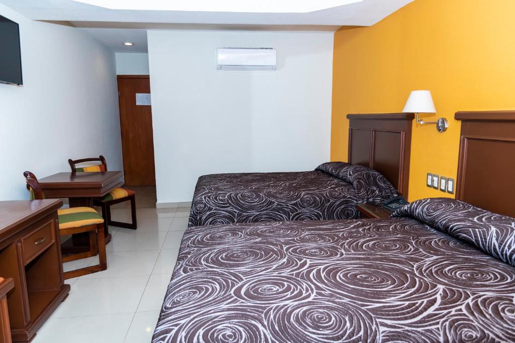 Postel nebo postele na pokoji v ubytování Hotel Gran Via - Centro
