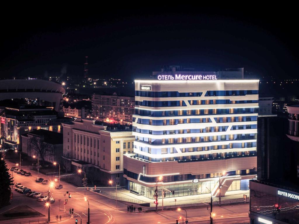 a lit up building in a city at night at Mercure Saransk Center in Saransk