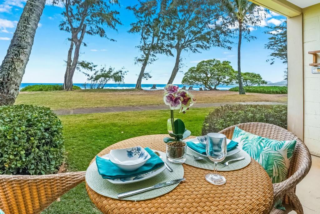 a picnic table with a view of the ocean at Islander on the Beach in Kapaa