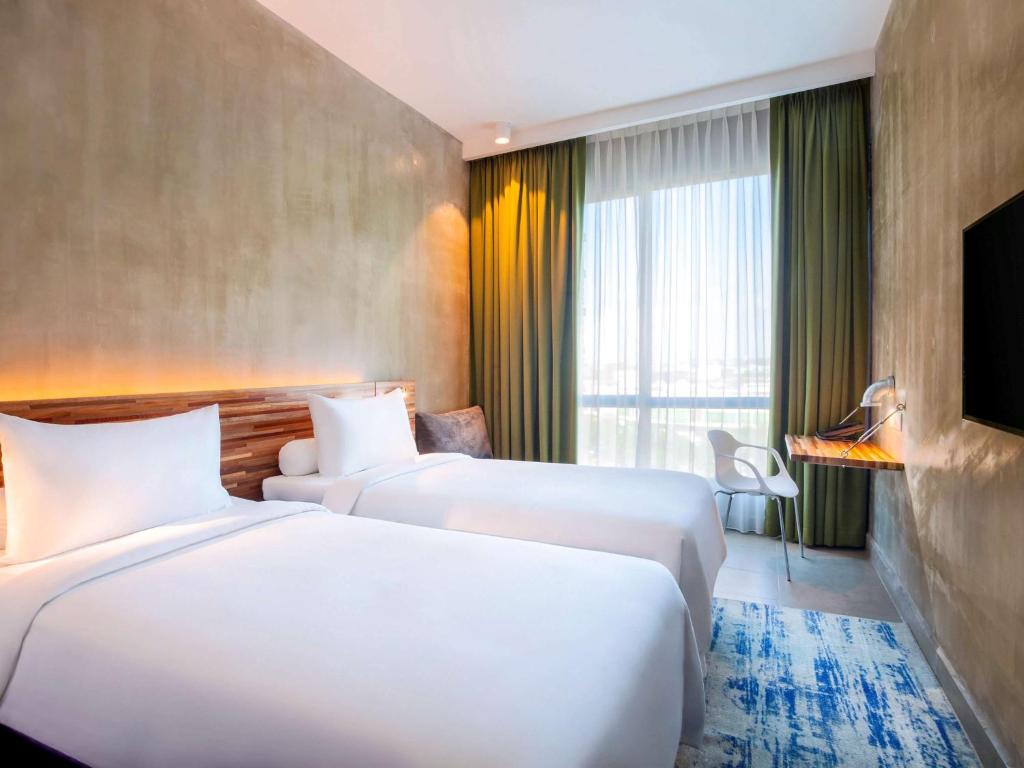 Postel nebo postele na pokoji v ubytování ibis Styles Kota Kinabalu Inanam