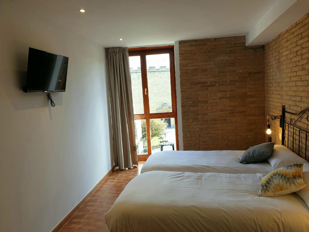 Postel nebo postele na pokoji v ubytování B&B La Atalaya