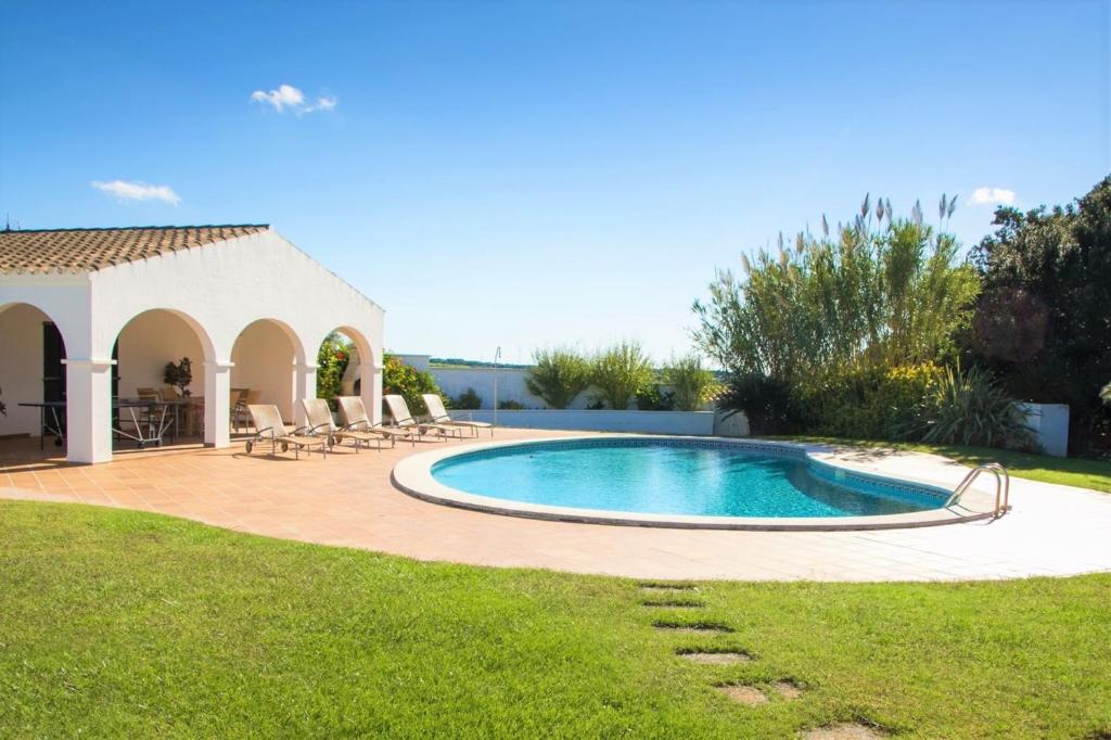 a swimming pool in a yard with a gazebo at Finca Calafi Nou in Ferreries