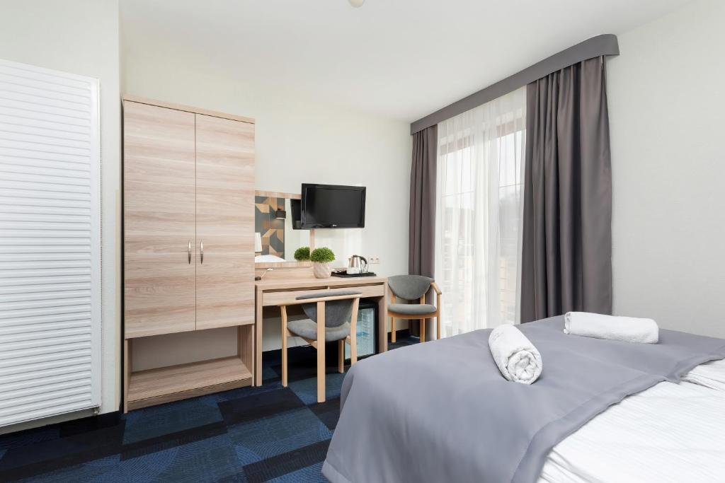 Postel nebo postele na pokoji v ubytování Nawigator SPA