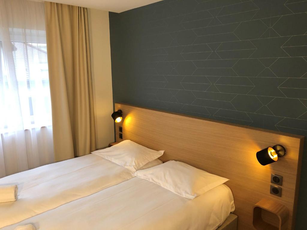 Postel nebo postele na pokoji v ubytování Oskar Hotel
