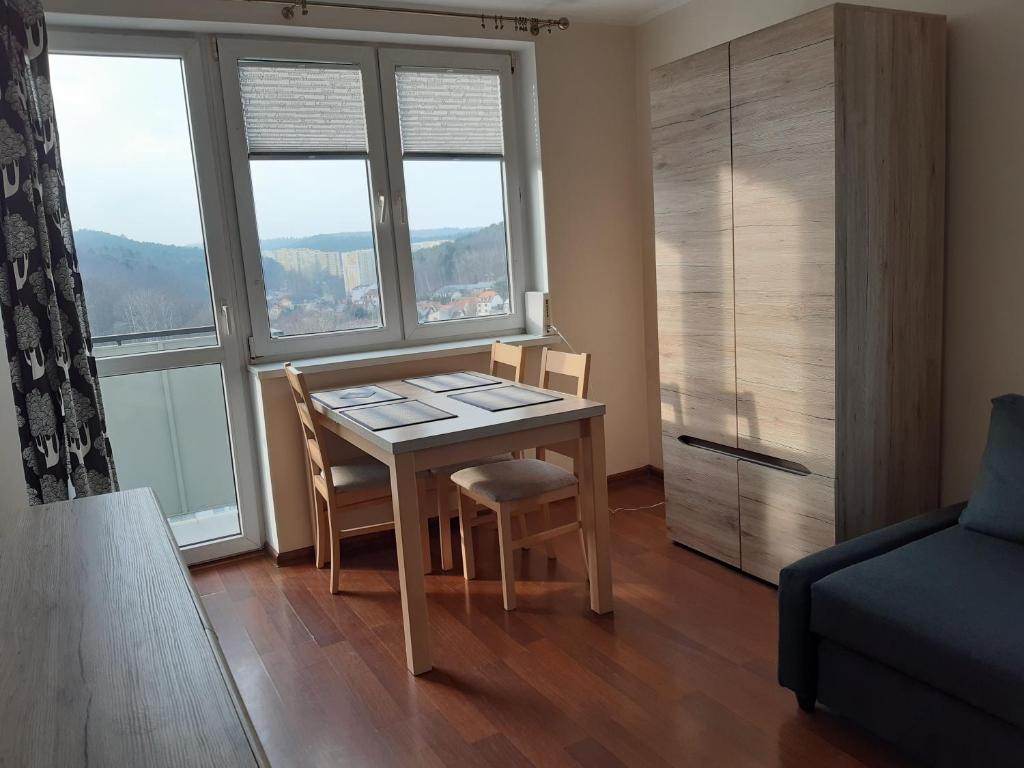 um quarto com uma mesa e cadeiras e uma janela em Viewpoint em Sopot