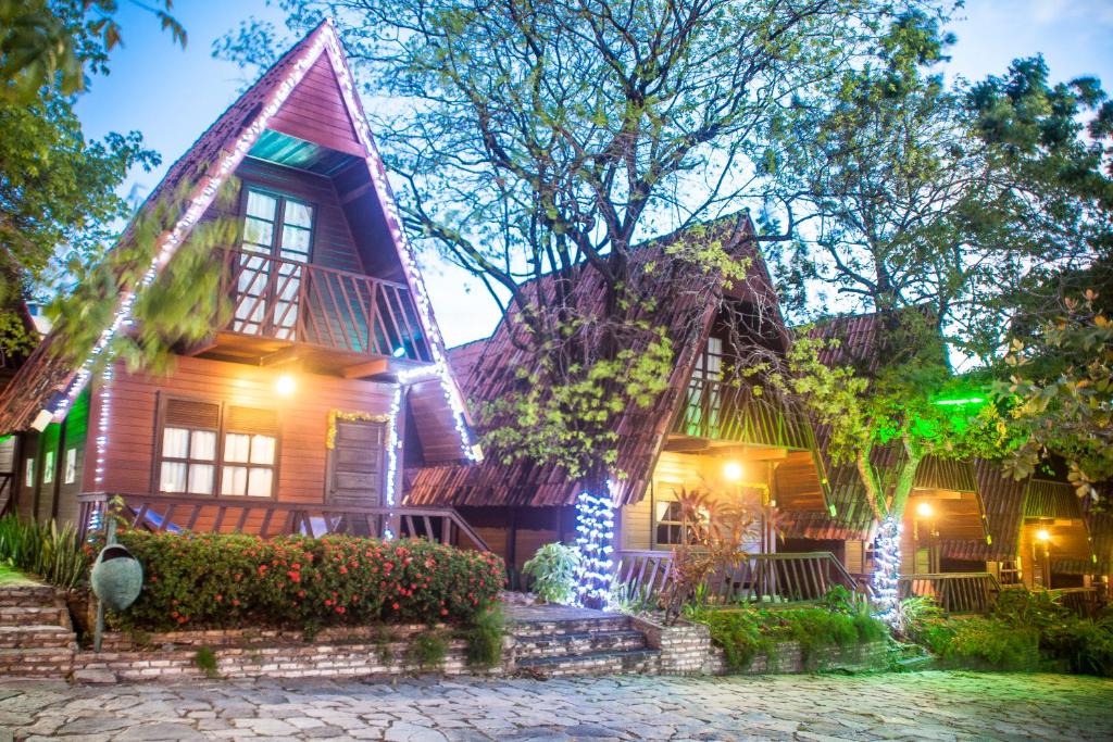 a home decorated for christmas at night at Chalet Suisse in Natal