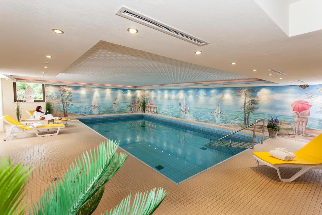 a swimming pool with a mural on the wall at Panorama Sonnenalm Hochschwarzwald in Todtnauberg