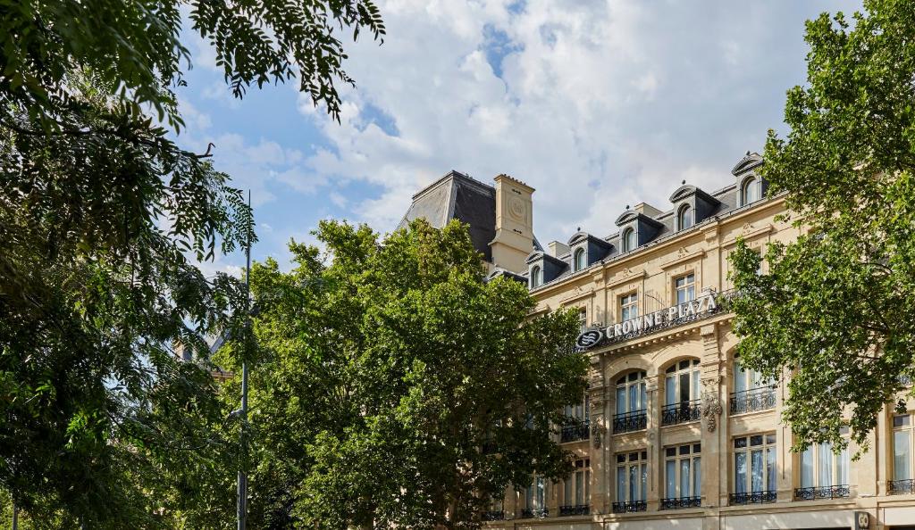 a large building with a clock on the top of it at Crowne Plaza Paris République, an IHG Hotel in Paris