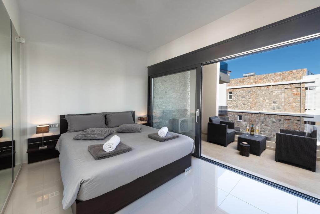 a bedroom with a large bed and a large window at Ixia Breeze 1 in Ixia