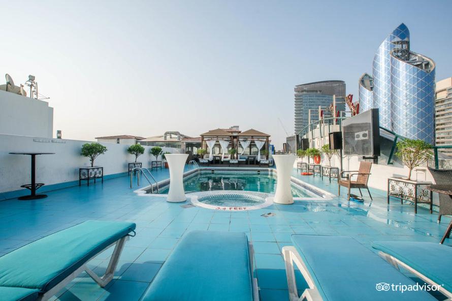 a swimming pool on the roof of a building at Regent Palace Hotel in Dubai